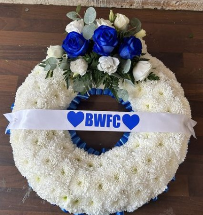 BWFC Football Wreath - A bespoke football-themed funeral wreath in classic white and bold blue tones, finished with a personalised BWFC ribbon for a meaningful and heartfelt tribute.