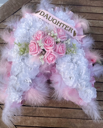 Angel Wings Tribute - A beautiful angel wings funeral tribute in soft pink and white tones, delicately finished for a meaningful and heartfelt farewell.