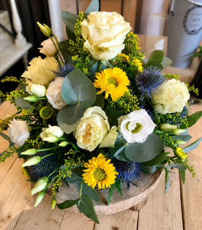 Traditional Yellow & White Posy - A beautiful funeral posy arranged in soft white and cheerful yellow tones, finished with fresh greenery for a natural and heartfelt tribute.