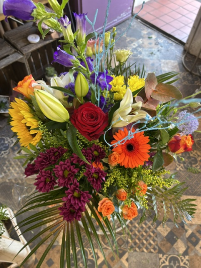 Colour Rush - A striking vase arrangement bursting with vibrant colour, bold blooms and lush foliage for a truly eye-catching display.
