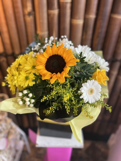 Bright and Cheerful - A cheerful arrangement of sunny yellows and crisp whites, beautifully finished with fresh greenery.
