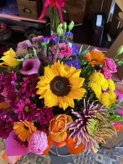 Wildly Wonderful - A show-stopping arrangement bursting with vibrant yellows, pinks, oranges and purples for a bold and joyful display.