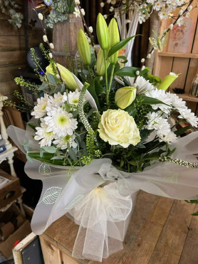 Pure & Beautiful - An elegant white arrangement beautifully presented with fresh greenery, delicate textures and graceful finishing touches.