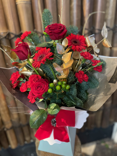 Crimson & Gold - A striking red arrangement with rich greenery and elegant gold accents, beautifully finished with a statement bow.