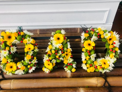 Yellow Letter Tribute - A vibrant personalised funeral letter tribute featuring cheerful yellow, white and green blooms with touches of red.