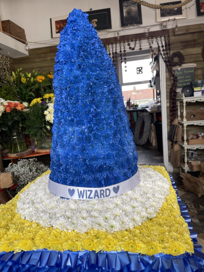 The Wizard - This unique floral art tribute stands 2.5 feet high and on a design board of 2ft by 2ft, it can be created in your choice of colour and the design changed to fit your requirements, please call to discuss